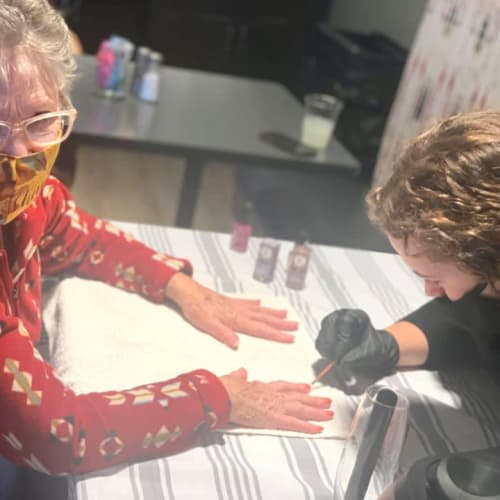 Resident getting her nails painted at Oxford Villa Active Senior Apartments in Wichita, Kansas