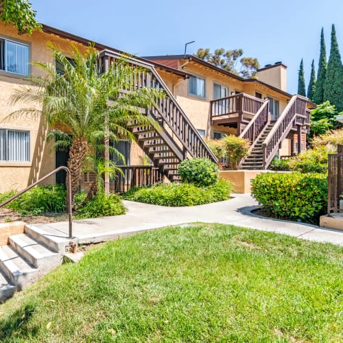 Exterior building view, lush grass and landscaping at Hillside Terrace Apartments in Lemon Grove