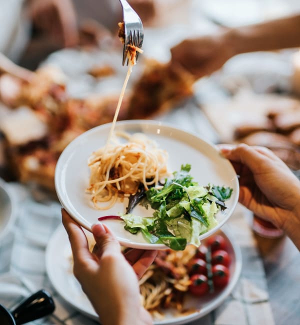 A group of people sharing plates of food near Riverstone in Macon, Georgia