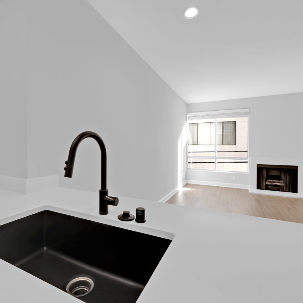 Black kitchen sink and white countertops at The Tower at Hollywood Hills, Los Angeles, California