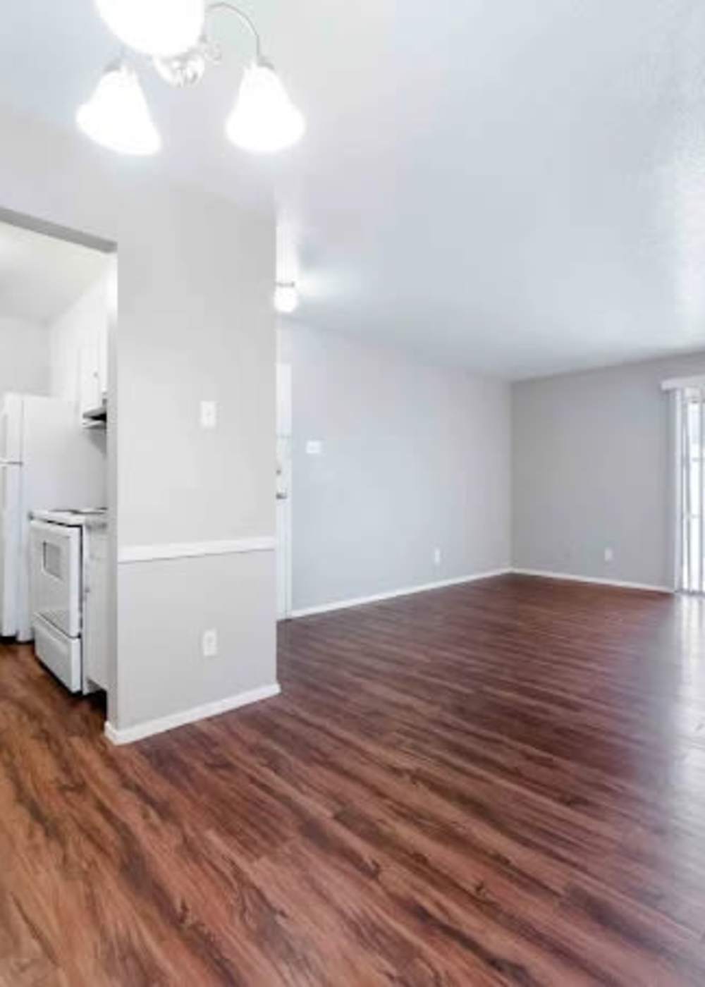 Unfurnished living room with wooden flooring at 2704 CDMX in Dallas, Texas