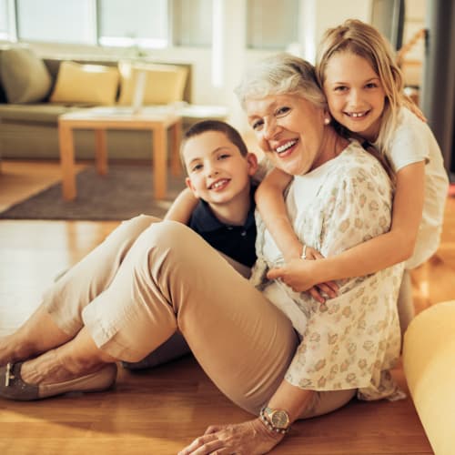 A grandma sitting on the floor with kids at JFSC in Norfolk, Virginia