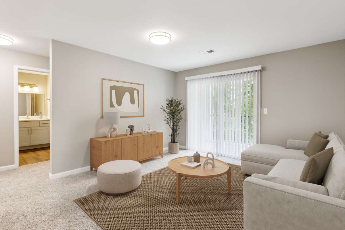Model living space with balcony at Barrington Parc in Moody, Alabama