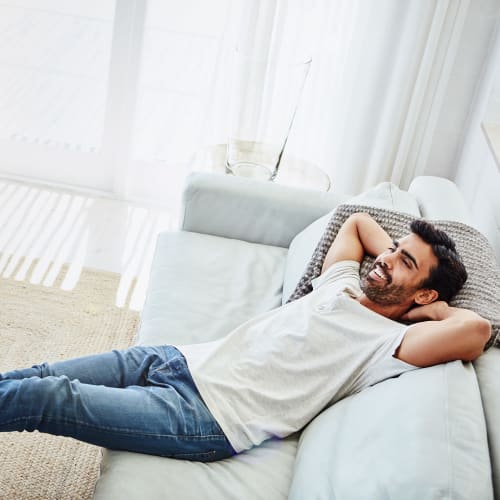 a resident lounging on the couch at Longshaw Road in Annapolis, Maryland