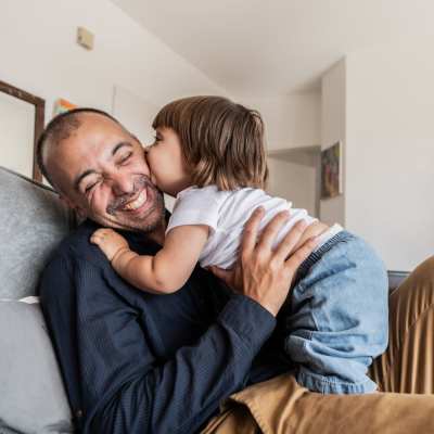 Happy resident with his kid at Mill Creek Apartments in Cross Plains, Wisconsin