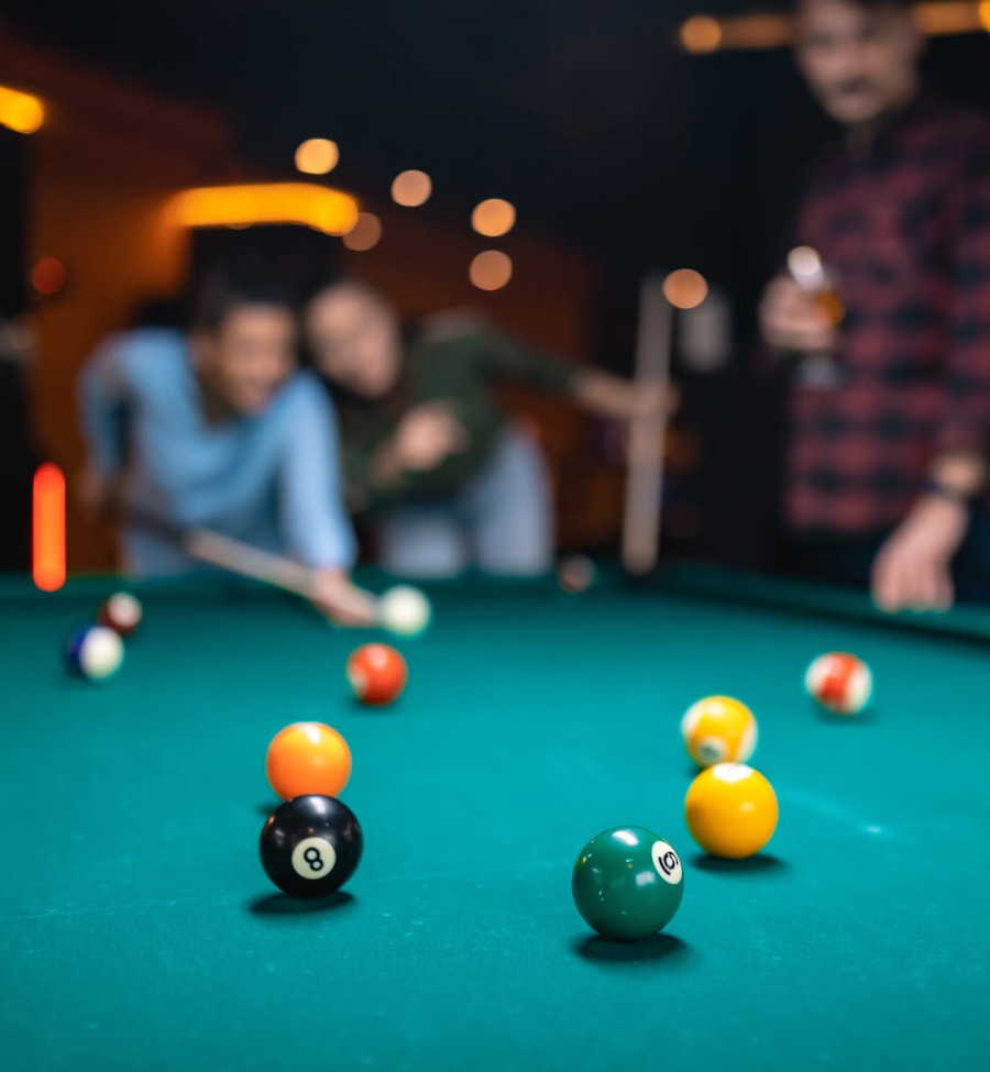 Friends playing pool near The Landing at St. Louis in Saint Louis, Missouri