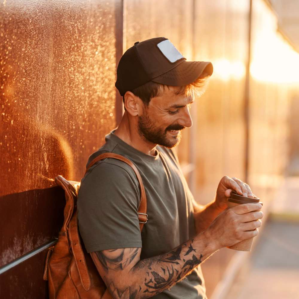 Man enjoying coffee outdoors at sunset The Simone in Silver Spring, Maryland