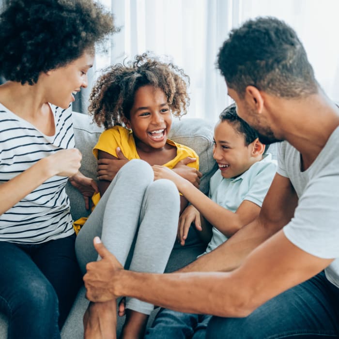 A family laughing in their apartment at Chesterfield Flats, North Chesterfield, Virginia