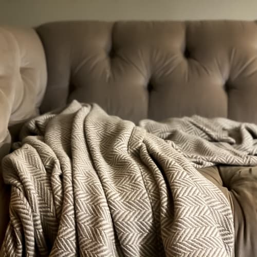 Blankets on a cozy couch at Mission University Pines in Durham, North Carolina