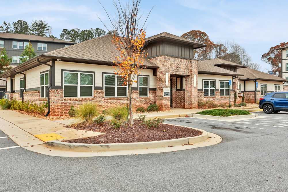 An exterior view showing apartment building with parking space at Flats at Mount Zion in Stockbridge, Georgia
