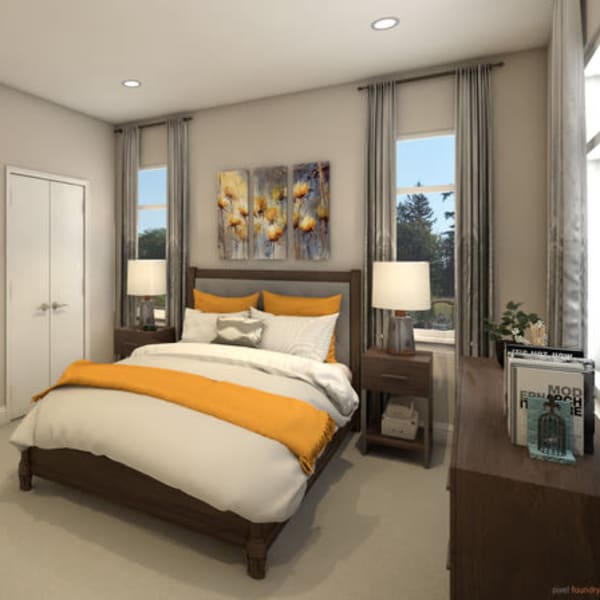Furnished bedroom with a large bed inside a cottage at Quail Park of Lynnwood in Lynnwood, Washington