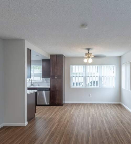 Open-concept of kitchen and living room at The Willows in Escondido, California