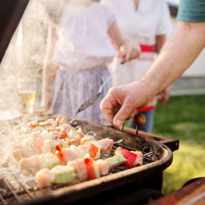 A resident barbequing food at South Mesa II in Oceanside, California