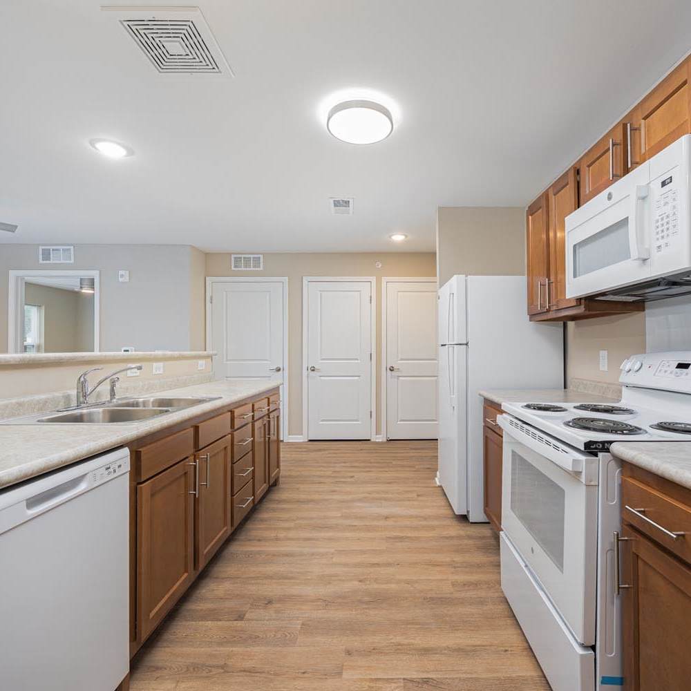 Modern kitchen with white appliances at The Enclave on Main in Whitehall, Ohio