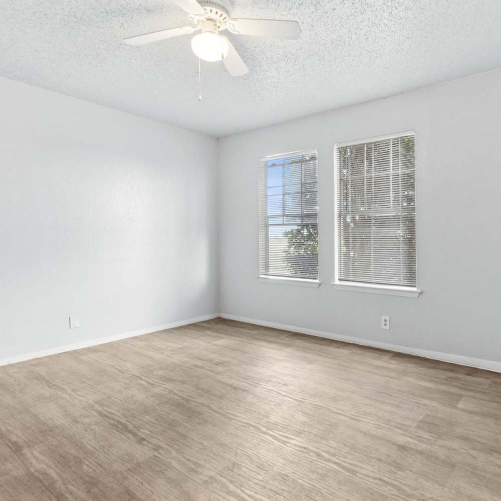 Apartment bedroom with windows at Arbors of Taylor in Taylor, Texas