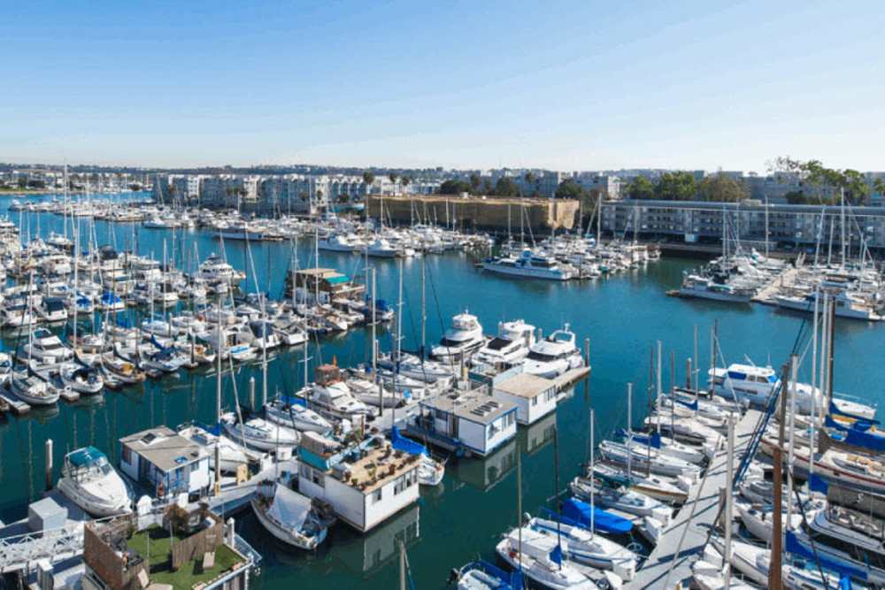 Luxury boats moored in a marina at Capri Apartments in Marina Del Rey, California