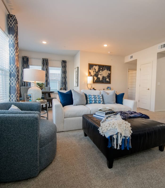 Spacious living room with large windows at Center 301 Apartments in Belton, Missouri