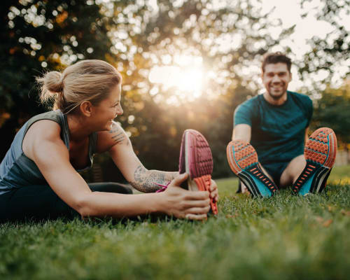 Residents stretch in a park near University Lofts at Russellville, Russellville, Arkansas