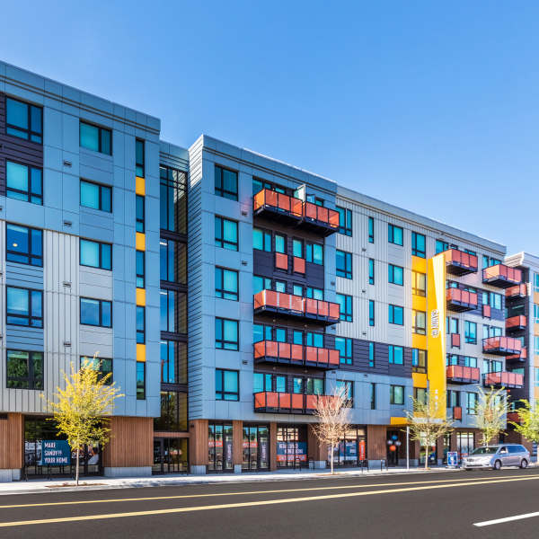 Exterior of apartment complex and surrounding neighborhood at Sandy Lofts in Portland, Oregon