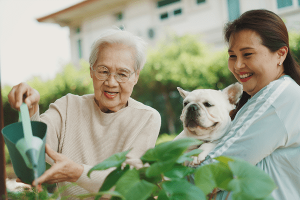 Resident watering flowers at Traditions of Cross Keys in Glassboro, New Jersey