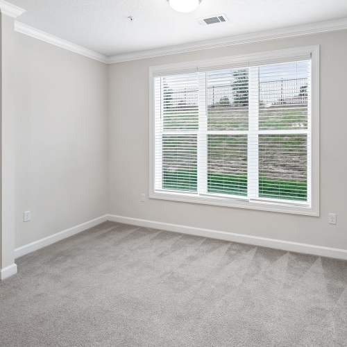 Living area with large windows and natural light at Brittany Place Hendersonville in Henderson, North Carolina