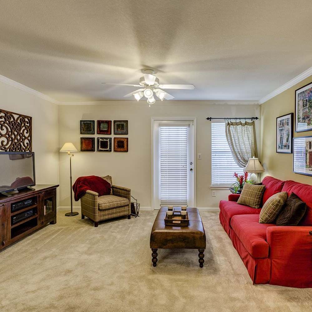 Living room with television and wooden flooring at Verandas at Mitylene in Montgomery, Alabama