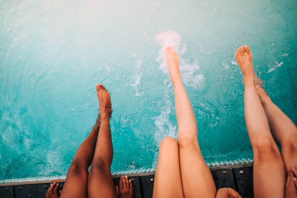 Residents escaping the heat, dipping their legs in the pool at Cahaba Grandview in Birmingham, Alabama