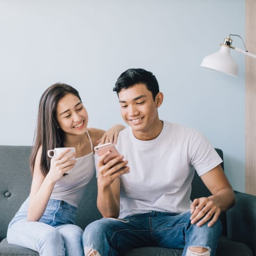 A couple setting on the couch at South Mesa I in Oceanside, California