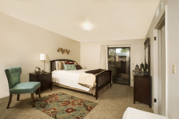 Master bedroom with modern decor at Pine Tree Apartments in Chico, California
