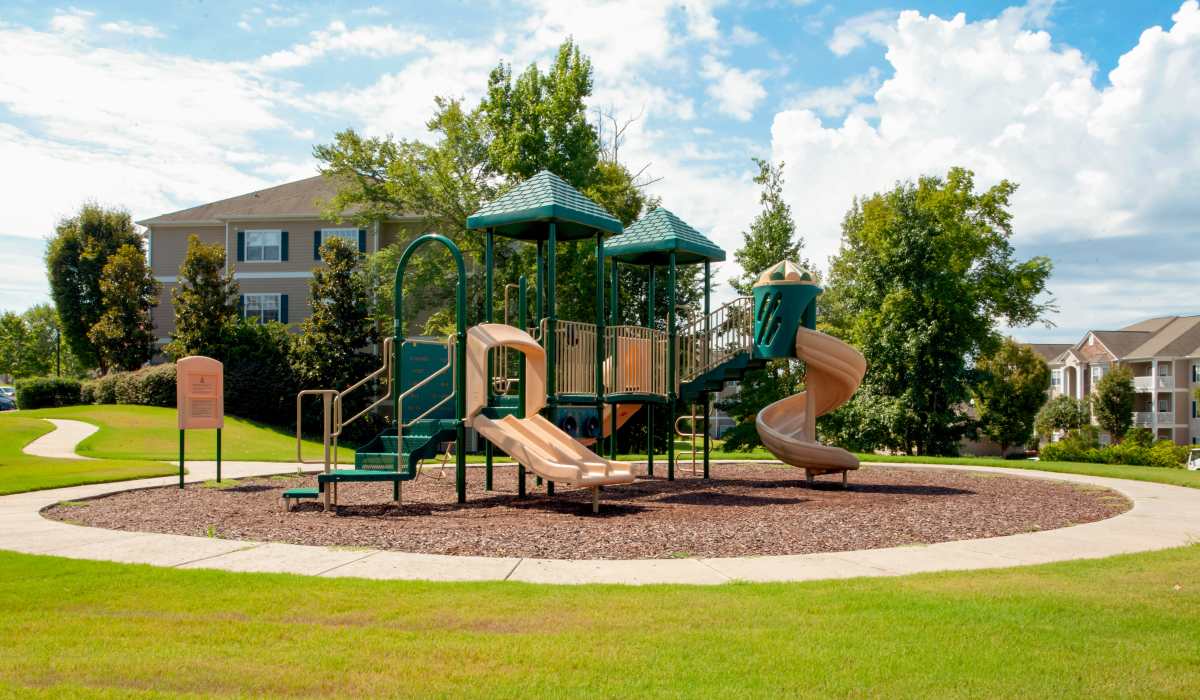 Community playground with multiple slides and climbing structure at Madison Park in Madison, Alabama