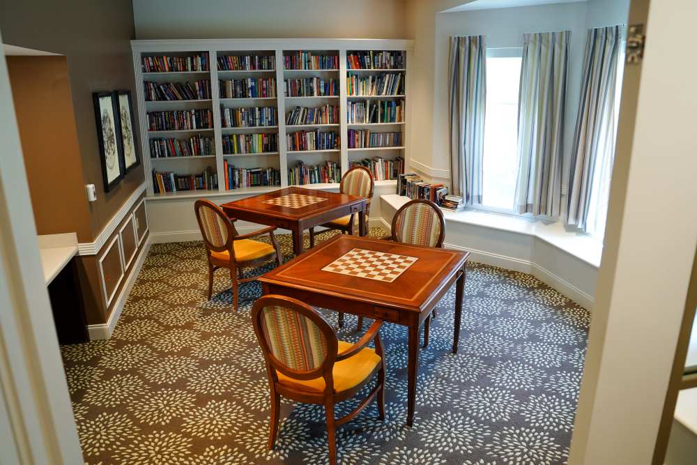 Indoor activity room with chess boards and bookshelf at Harmony on the Peninsula in Yorktown, Virginia