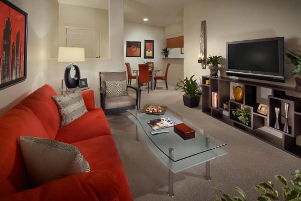 Modern decorated living room with ceiling fan at San Hacienda in Chandler, Arizona