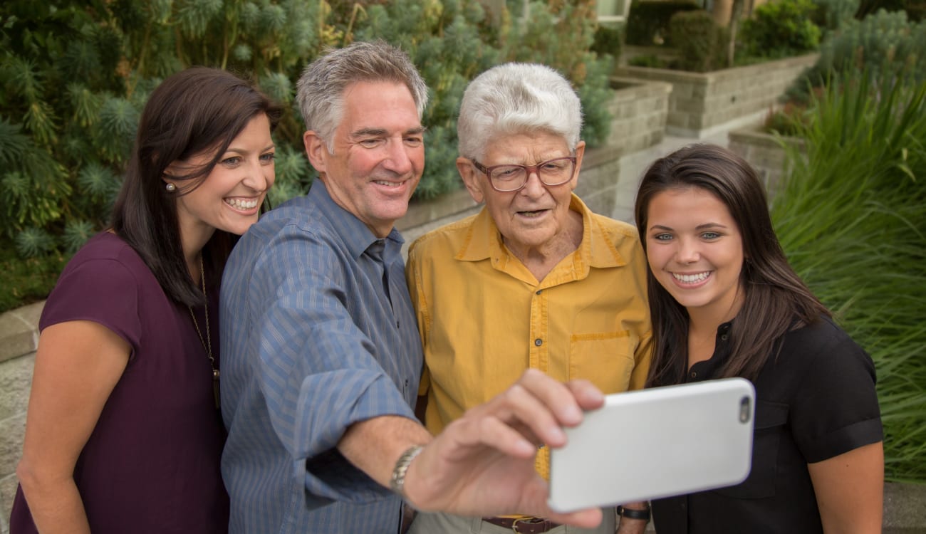 A resident and his family pose for a picture at Merrill Gardens. 