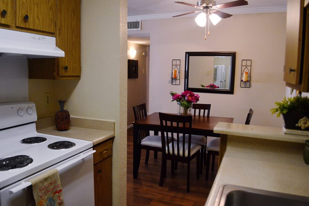 An apartment kitchen and dining room with wood style flooring at Villa Bella in Euless, Texas