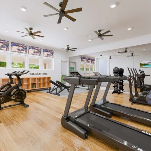 Modern fitness center with wood-style flooring at Russ Town Crossing in Ruston, Louisiana