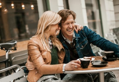 Resident couple enjoying coffee while they take a break from shopping downtown near Rockbrook Creek in Lewisville, Texas
