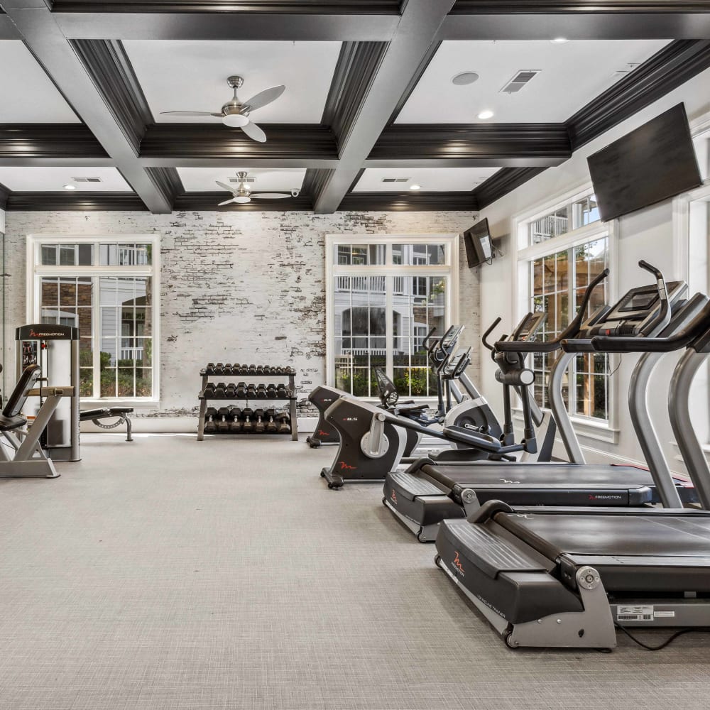 Fitness center with cardio equipment and free weights at Five Oaks in Tucker, Georgia