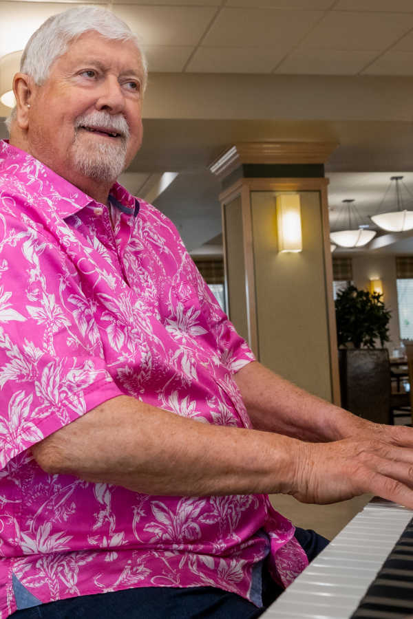 Resident playing piano at Merrill Gardens in Seattle, Washington
