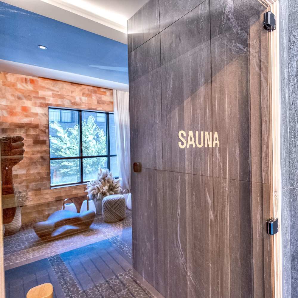 Elegant sauna entry with modern wooden finishes and spacious design at Green|House Short North in Columbus, Ohio