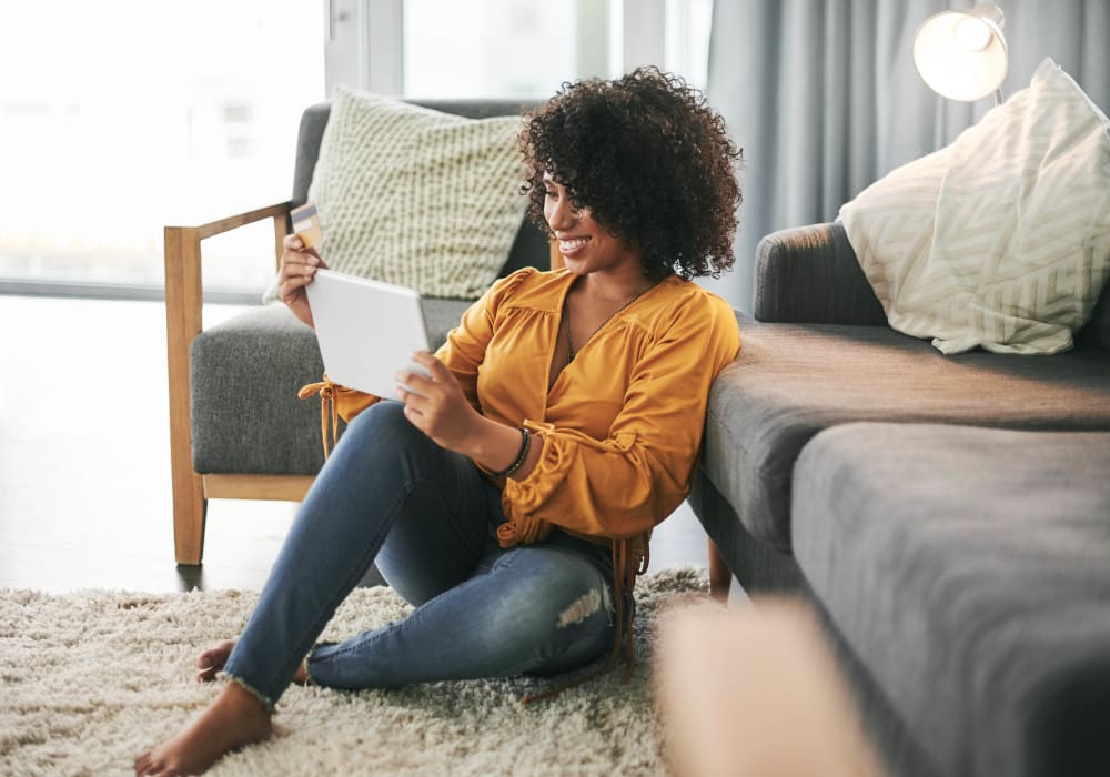 Woman enjoying her living room at Hollybrook Farms Apartments in Laurel, Delaware