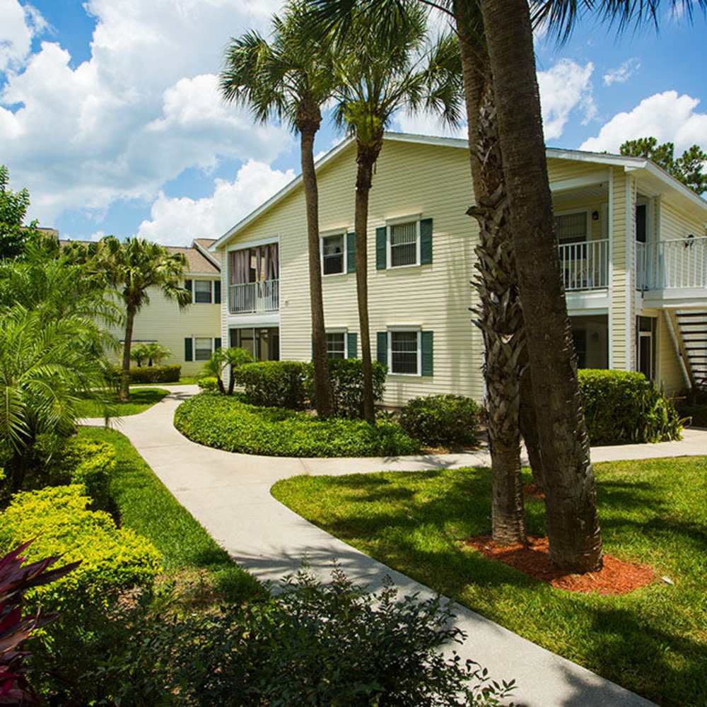 Charming multi-unit property surrounded by lush landscaping at Park Place Apartments in Port Richey, Florida.