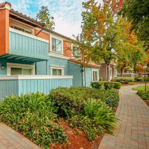 Apartment building exterior with private balconies at Peppertree Apartments in San Jose, California