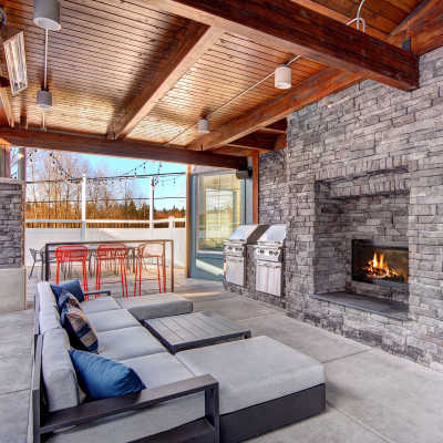 BBQ grilling area and outdoor lounge area with fireplace at Allegro in Lynnwood, Washington