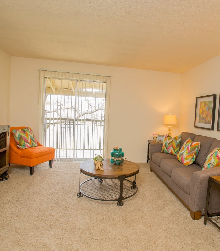 Spacious living room with large windows at Country Hollow in Tulsa, Oklahoma