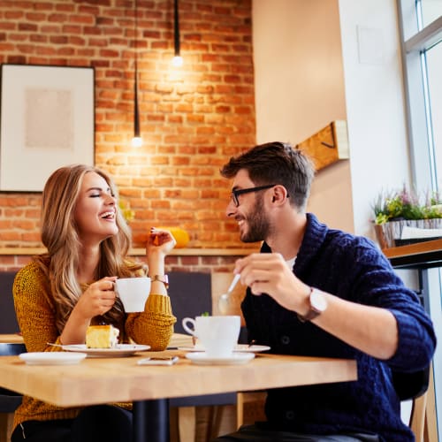 A couple having their coffee at cafe near Prospect View in Santee, California