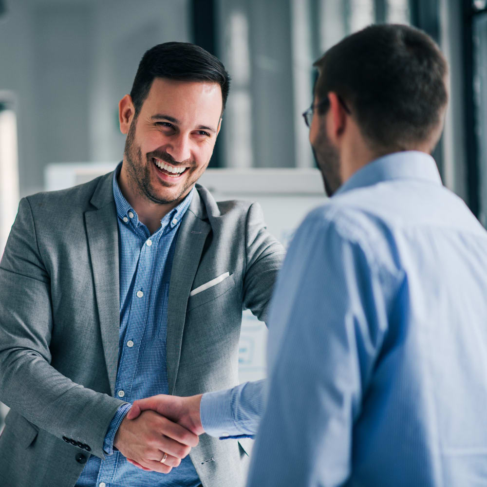 Business partners shaking hands over a recent acquisition at Devon Self Storage