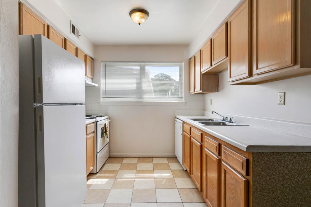 Large kitchen with wood cabinets and a refrigerator at Admiral's Way in Norfolk, Virginia
