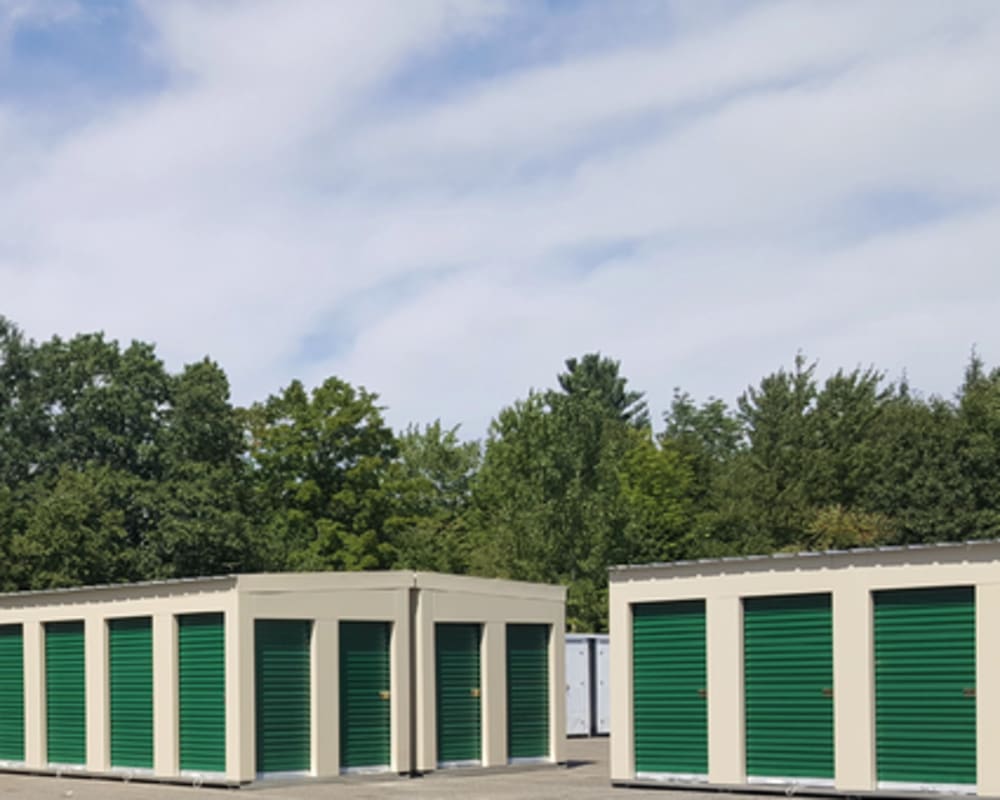 A row of outdoor units with green doors at 603 Storage - Candia in Candia, New Hampshire