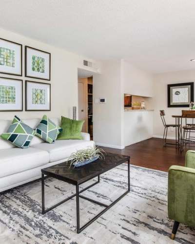 Spacious living room with connecting dining area at Creekside Villas at Clear Lake Apartments in Houston, Texas