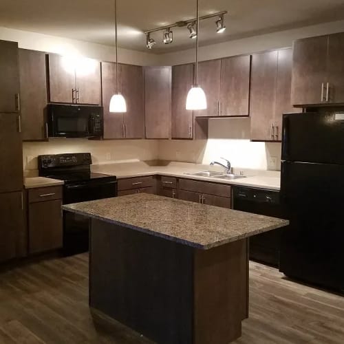 Beautiful kitchen with granite countertops at Mill Creek Apartments in Cross Plains, Wisconsin